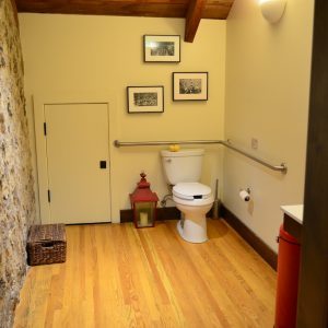 The ADA-compliant restroom at Keenan Winery, with grab rails and a wide turning space
