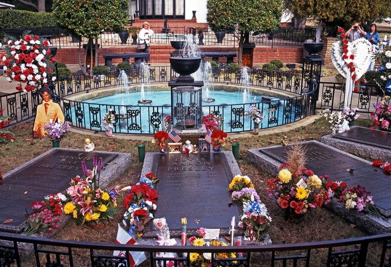 The Meditation Garden at Graceland, graves banked with flowers around a fountain