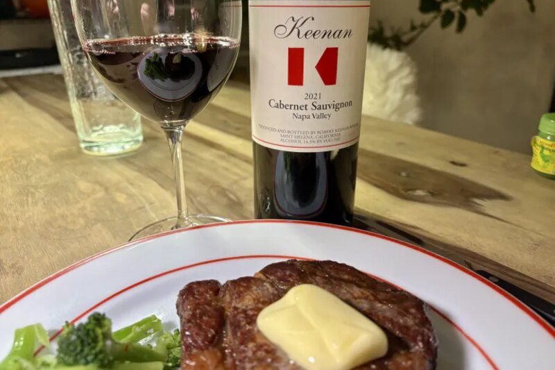 A reverse-seared Wagyu chuck eye with melting butter, beside the Keenan 2021 Cabernet Sauvignon