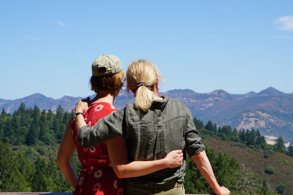 Two people on the Keenan estate looking out over the forested ridgeline