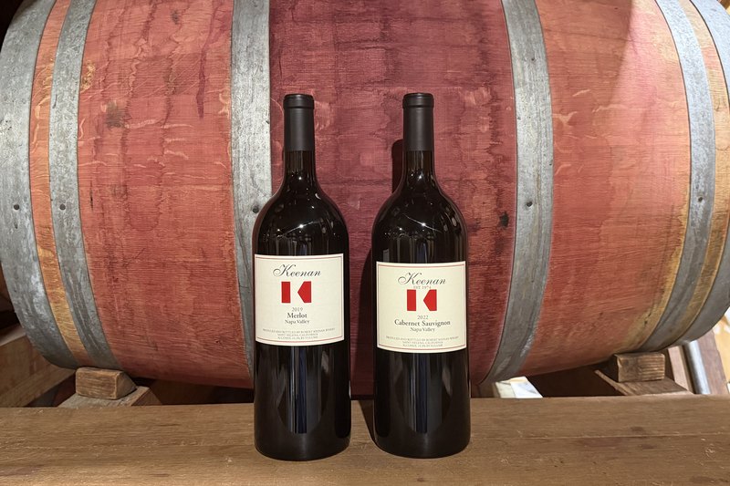 The Keenan Magnum Club shipment against a barrel — two magnums of Keenan red