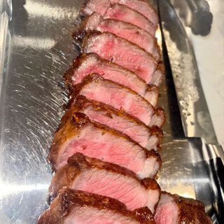 The cooked strip sliced against the grain, showing an even rose interior