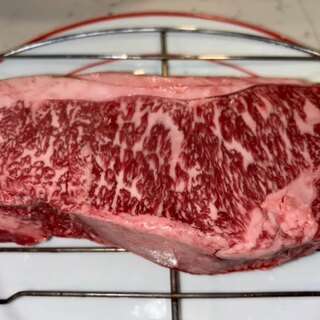The raw Vermont Wagyu New York strip, showing its even marbling