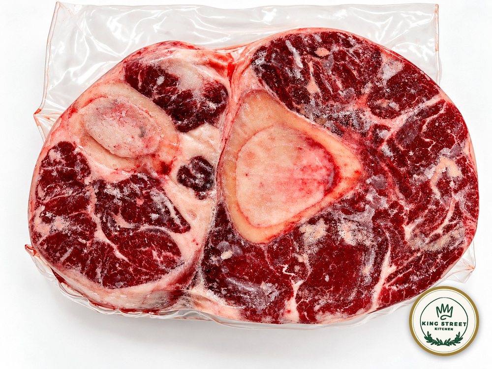 A cross-cut Vermont Wagyu beef shank in its wrapping, the marrow bone at its center