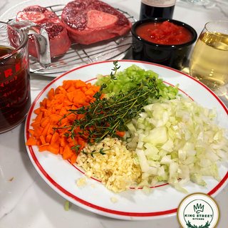 Diced carrot, celery and onion, grated garlic and thyme, prepped beside the shanks, tomatoes and white wine