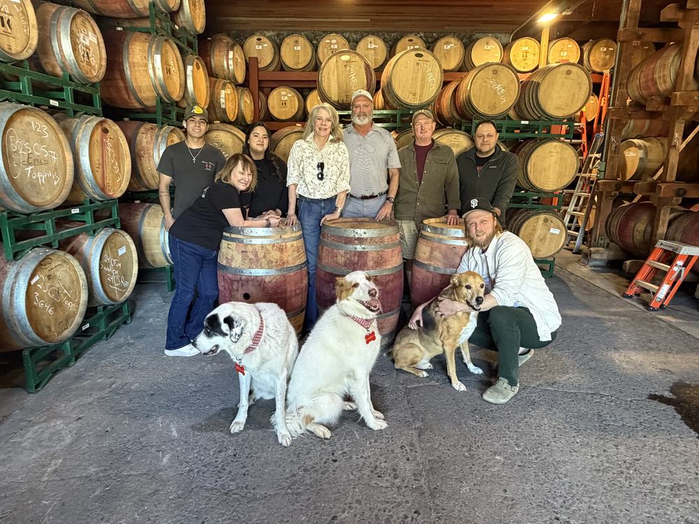 The Keenan team and the winery dogs in the barrel room