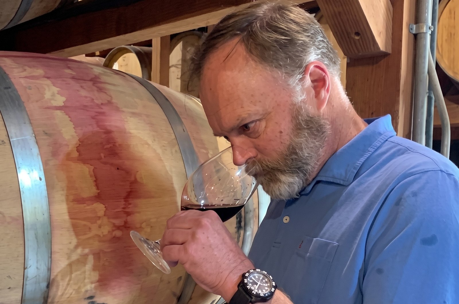 Michael Keenan nosing a barrel sample beside a French oak barrel in the Keenan cellar